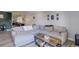 Open living room with gray sectional, side table, and plank flooring at 7201 E Quincy Ave # 103, Denver, CO 80237