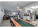 Open-concept living space featuring a modern kitchen, dining area, and fireplace at 7201 E Quincy Ave # 103, Denver, CO 80237