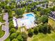 Aerial view of the community pool and clubhouse offers a glimpse of the available amenities at 7899 E 28Th Pl, Denver, CO 80238