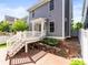 Charming backyard boasts a wooden deck, a stone retaining wall, and lush landscaping at 7899 E 28Th Pl, Denver, CO 80238