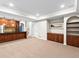 Finished basement includes a wet bar with wood paneling and carpeted floors at 7899 E 28Th Pl, Denver, CO 80238
