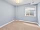 Cozy bedroom features a neutral color scheme, plush carpeting, and a window for natural light at 7899 E 28Th Pl, Denver, CO 80238