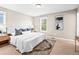 Bright bedroom with a plush bed, neutral decor, and ample natural light at 7899 E 28Th Pl, Denver, CO 80238