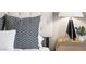 Close up of a modern bedroom showing decorative pillows and a bedside lamp at 7899 E 28Th Pl, Denver, CO 80238