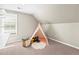 Carpeted bonus room features a window with backyard view and a play tent at 7899 E 28Th Pl, Denver, CO 80238