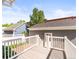 This deck showcases a white railing with views of the neighboring yards and lush greenery at 7899 E 28Th Pl, Denver, CO 80238