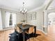 Elegant dining room with stylish chandelier, hardwood floors, and sophisticated decor at 7899 E 28Th Pl, Denver, CO 80238