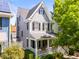 An inviting two-story home features a charming front porch and well-manicured landscaping at 7899 E 28Th Pl, Denver, CO 80238