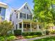Charming two-story home featuring a welcoming front porch, manicured landscaping, and classic architectural details at 7899 E 28Th Pl, Denver, CO 80238