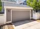 Detached two-car garage with gray horizontal siding and white trim at 7899 E 28Th Pl, Denver, CO 80238