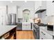 Modern kitchen featuring stainless steel appliances, white cabinets, and a farmhouse sink at 7899 E 28Th Pl, Denver, CO 80238