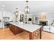 Open-concept kitchen and living space with hardwood floors and a view of the cozy fireplace at 7899 E 28Th Pl, Denver, CO 80238