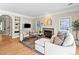 Cozy living room with fireplace, built-in shelving, and hardwood floors at 7899 E 28Th Pl, Denver, CO 80238