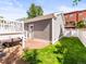 Yard features a white fence and a detached garage at 7899 E 28Th Pl, Denver, CO 80238