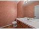 Half bathroom featuring wood floors, salmon color walls, standard toilet, and a white tiled countertop at 3310 W 98Th Ave # B, Westminster, CO 80031