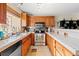 Well-equipped kitchen with wood cabinets and tiled countertops at 18234 E Arizona Ave # E, Aurora, CO 80017