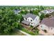 Aerial view of the home showcasing its covered patio, well-maintained yard, and proximity to lush green spaces at 1873 Trevor Cir, Longmont, CO 80501
