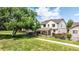 Scenic view of the home's backyard featuring a spacious lawn, covered patio, and beautiful landscaping at 1873 Trevor Cir, Longmont, CO 80501
