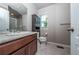 Bathroom features a modern vanity, granite countertop, a window, and a glass-enclosed shower at 1873 Trevor Cir, Longmont, CO 80501