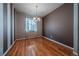 Elegant dining room with hardwood floors, a chandelier, and a large window at 1873 Trevor Cir, Longmont, CO 80501