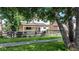 Charming home exterior featuring a covered patio and inviting backyard, nestled among mature trees and lush greenery at 1873 Trevor Cir, Longmont, CO 80501