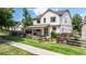 Charming two-story home with a well-manicured lawn, inviting patio, and classic architectural details at 1873 Trevor Cir, Longmont, CO 80501