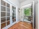 Welcoming foyer with hardwood floors, glass paneled doors, and a view of the front porch at 1873 Trevor Cir, Longmont, CO 80501