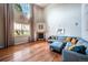Spacious living room with a fireplace, hardwood floors, and a large window at 1873 Trevor Cir, Longmont, CO 80501