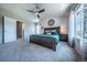 Large main bedroom featuring a ceiling fan, plush carpeting, and generous natural light at 1873 Trevor Cir, Longmont, CO 80501