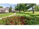 Picturesque neighborhood scene with a walking path, colorful flower beds, and charming single-Gathering homes at 1873 Trevor Cir, Longmont, CO 80501