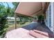Extended covered patio showcases stained concrete flooring, integrated lighting, and views of the grassy backyard at 1873 Trevor Cir, Longmont, CO 80501