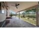 Spacious covered patio with a ceiling fan and decorative stamped concrete flooring, ideal for outdoor entertaining at 1873 Trevor Cir, Longmont, CO 80501