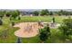 Community playground with multiple play structures, surrounded by green lawns and mature trees at 1873 Trevor Cir, Longmont, CO 80501
