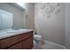 Stylish powder room with decorative wall art, a modern sink, and vinyl floors at 1873 Trevor Cir, Longmont, CO 80501