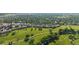 Golf course aerial view showing a well-manicured green landscape with trees and residential areas in the distance at 8035 S Garfield Way, Centennial, CO 80122