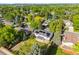 Neighborhood aerial view showcases lush landscaping, mature trees and residential homes with solar panels at 8035 S Garfield Way, Centennial, CO 80122