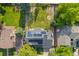An aerial view of a home with solar panels and a spacious backyard featuring a playground and garden at 8035 S Garfield Way, Centennial, CO 80122
