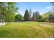 Lush backyard featuring a well-maintained lawn and mature trees, providing a serene outdoor space at 8035 S Garfield Way, Centennial, CO 80122