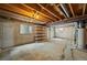 Unfinished basement space featuring exposed wooden beams, shelving, and a small window for natural light at 8035 S Garfield Way, Centennial, CO 80122