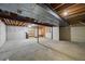 Unfinished basement space with visible beams, concrete floor, and potential for customization at 8035 S Garfield Way, Centennial, CO 80122