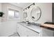 Modern bathroom featuring double sinks, marble countertop, and decorative mirrors at 8035 S Garfield Way, Centennial, CO 80122