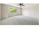 Spacious bedroom with a ceiling fan, plush carpeting, and a large window overlooking a bright and airy view at 8035 S Garfield Way, Centennial, CO 80122