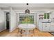 Sun-filled breakfast nook with round white table set near a large window with a view of the yard at 8035 S Garfield Way, Centennial, CO 80122