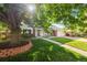 Charming home with lush green lawn and mature tree shading the front, creating a welcoming curb appeal at 8035 S Garfield Way, Centennial, CO 80122