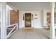 Inviting front porch with stylish security door, showcasing a 'hello' doormat and brick accents at 8035 S Garfield Way, Centennial, CO 80122