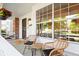 Cozy front porch featuring wicker seating, hanging flowers, and a welcoming 'hello' mat for guests at 8035 S Garfield Way, Centennial, CO 80122