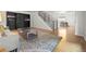 Spacious living room with hardwood floors, staircase, and a view into the dining area at 8035 S Garfield Way, Centennial, CO 80122