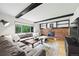 Comfortable living room with fireplace, exposed beam and large sectional couch overlooking backyard at 8035 S Garfield Way, Centennial, CO 80122