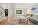 Bright living room featuring hardwood floors, a large window, comfortable seating, and modern staircase at 8035 S Garfield Way, Centennial, CO 80122