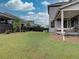 Spacious backyard with green lawn, black fence, and covered patio at 11246 Bellsong Ln, Littleton, CO 80125